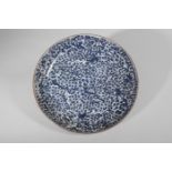 Plat en porcelaine décorée en bleu cobalt sous couverte de pivoines stylisées Chine Dynastie Qing