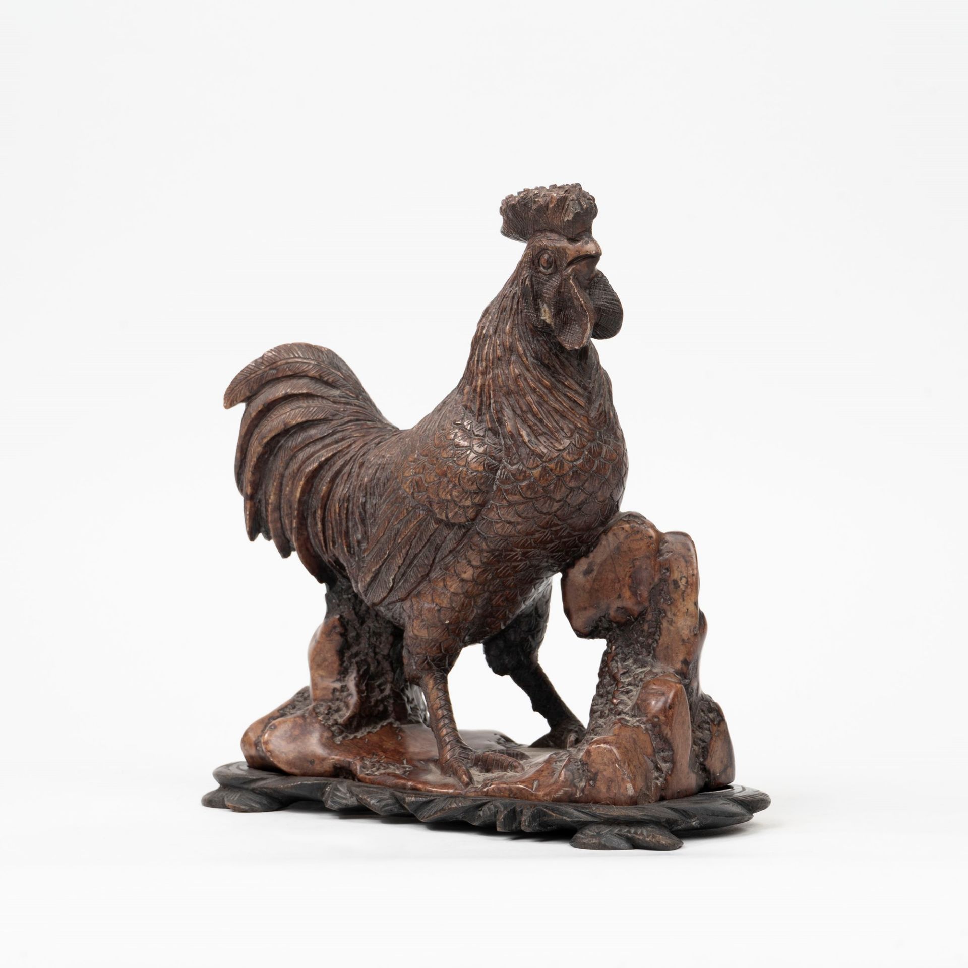 Soapstone sculpture depicting a rooster with wooden base, China, early 20th century