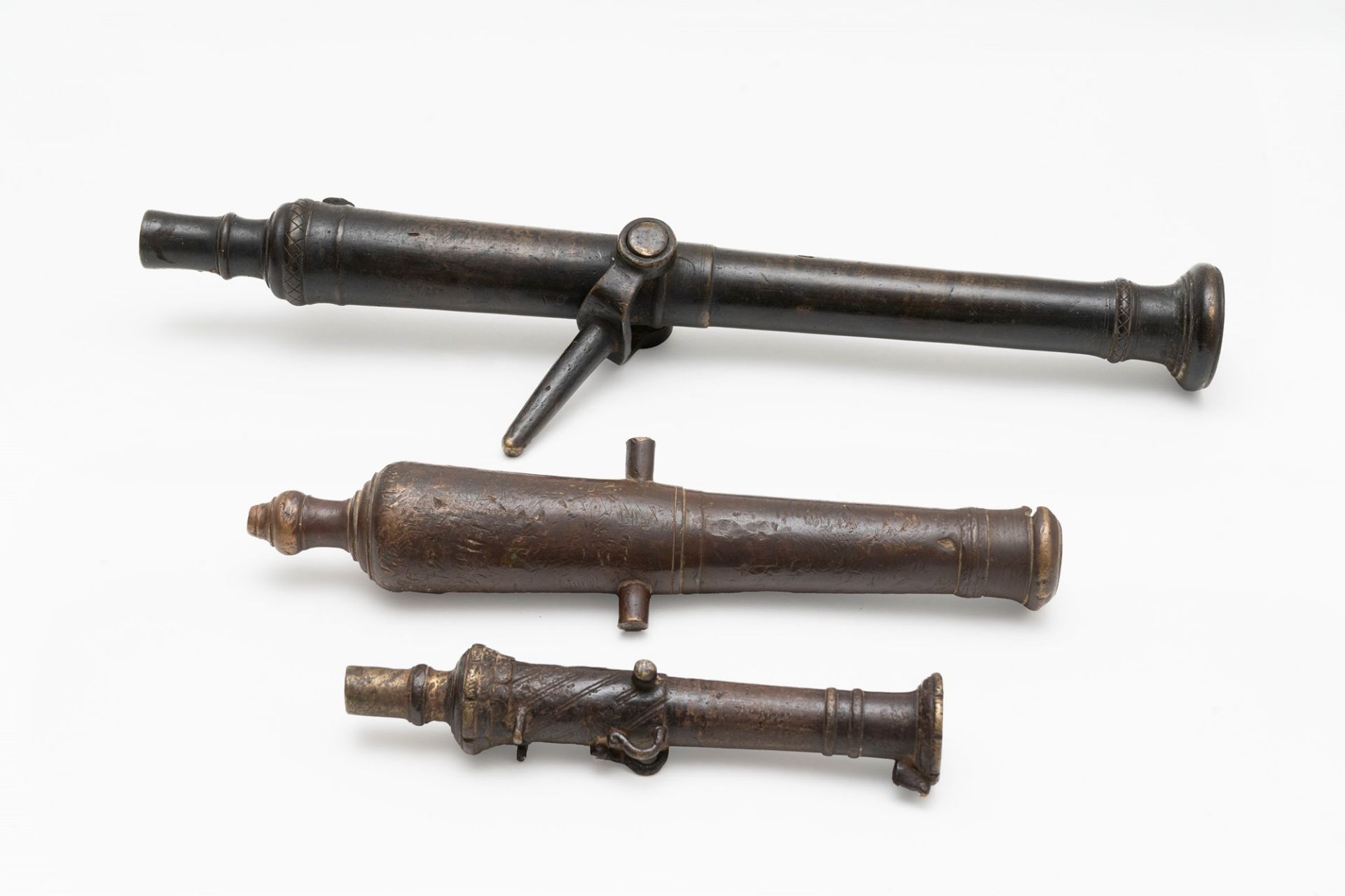 Three ancient bronze cannon models