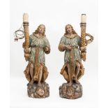 Two carved and lacquered wooden angel-candelabra, 18th century