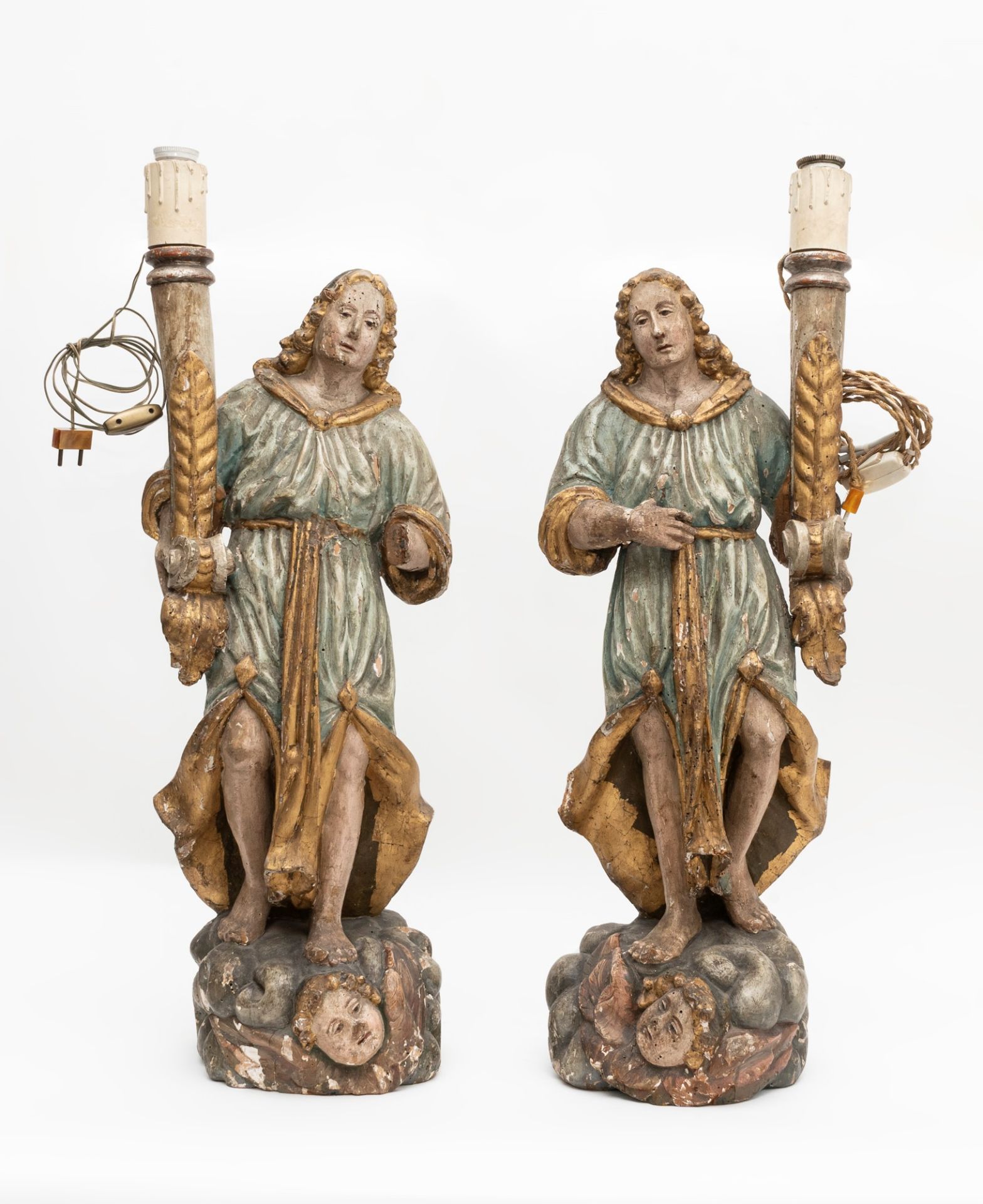 Two carved and lacquered wooden angel-candelabra, 18th century