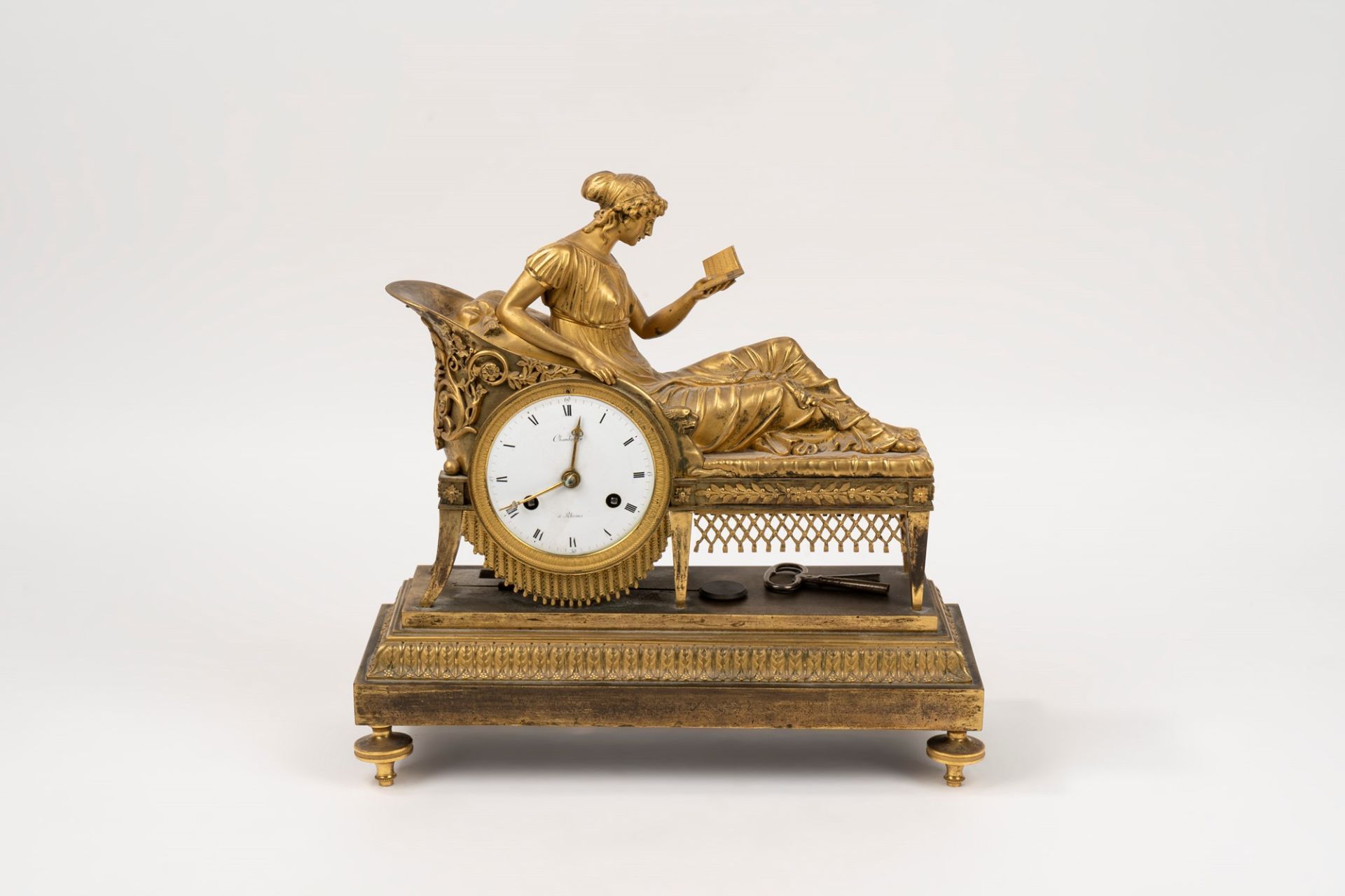Empire clock in gilded bronze representing Madame Recamier reading, early 19th century
