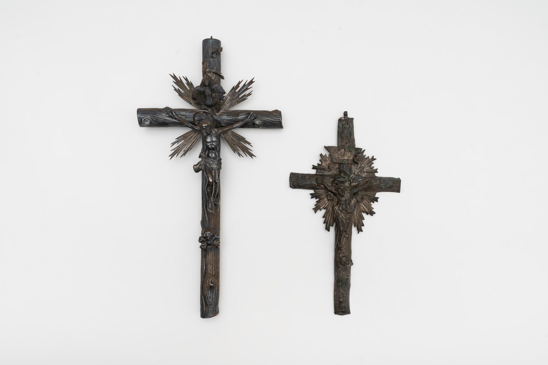 Lot consisting of two silver crucifixes and three miniatures, late 19th century - early 20th century