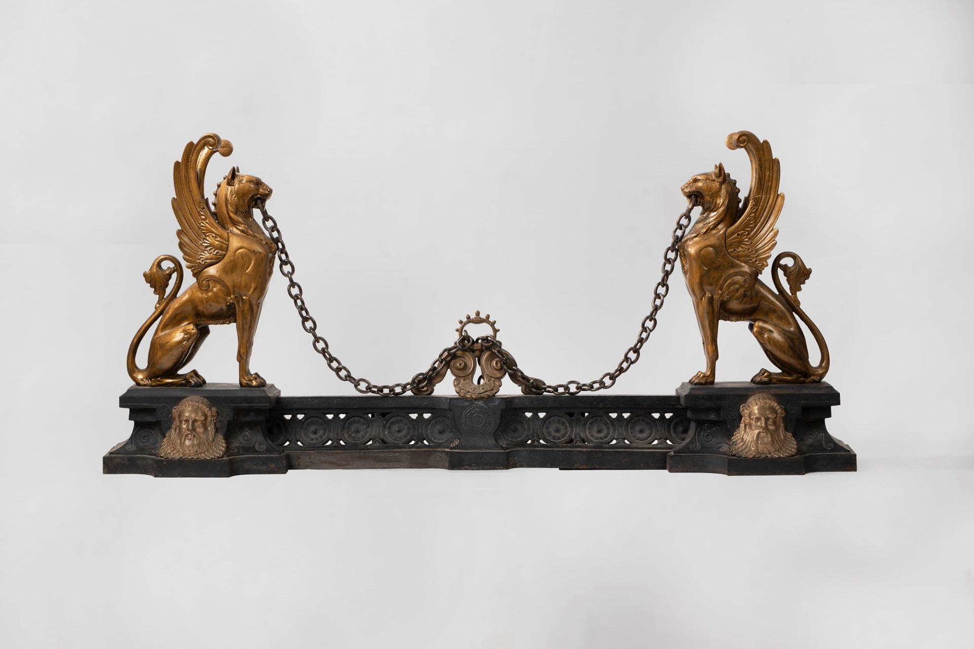 Pair of iron andirons with winged lions, 19th century