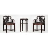 Pair of armchairs and a carved wooden table in oriental style, 20th century
