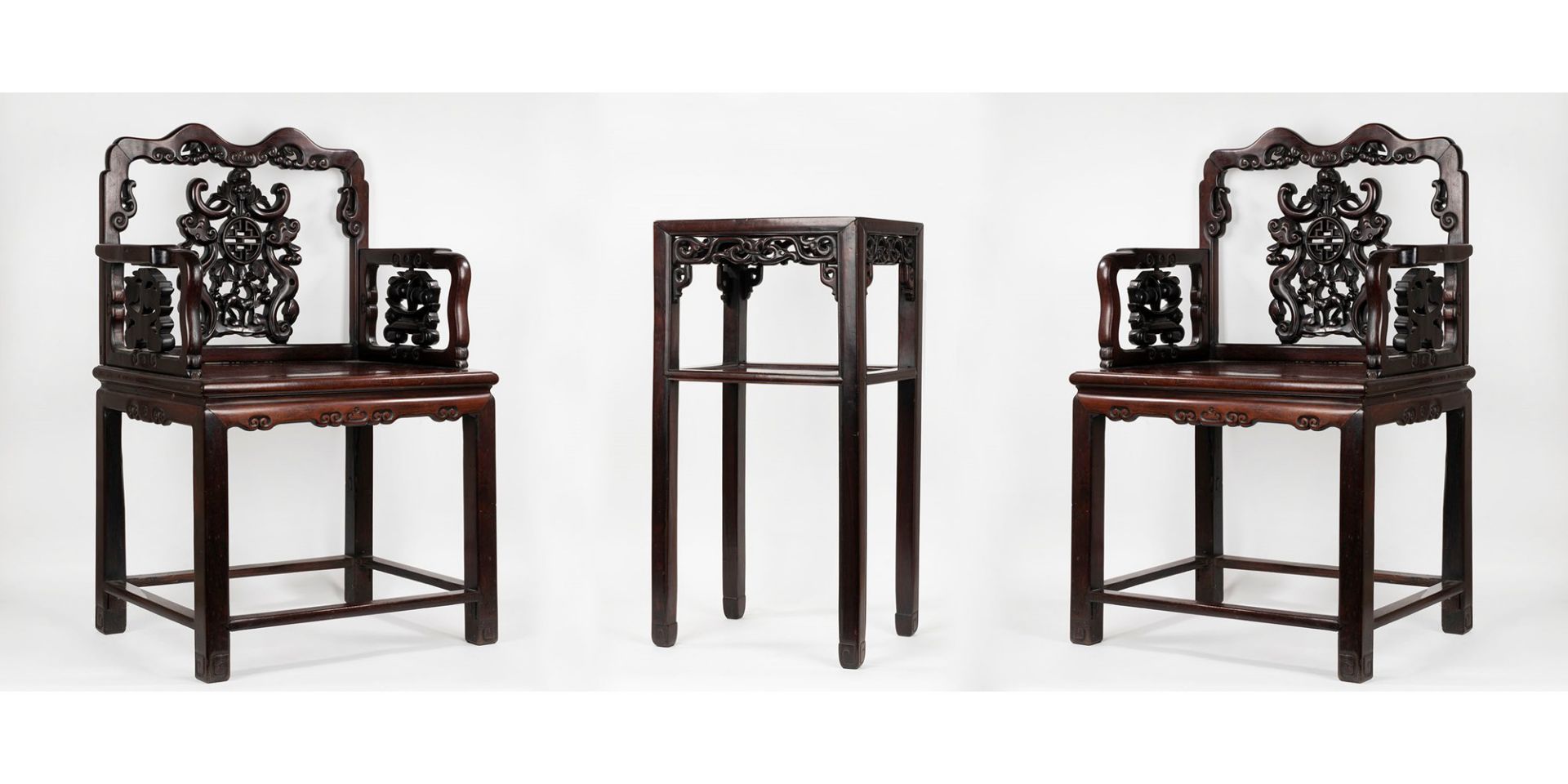 Pair of armchairs and a carved wooden table in oriental style, 20th century