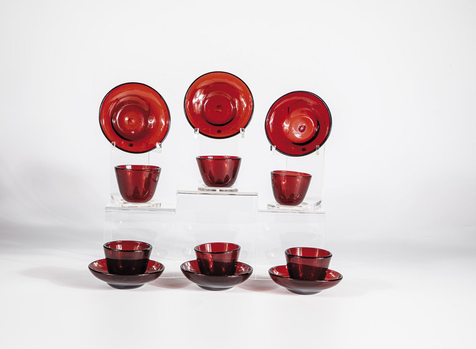 Six heads with gold ruby glass bases