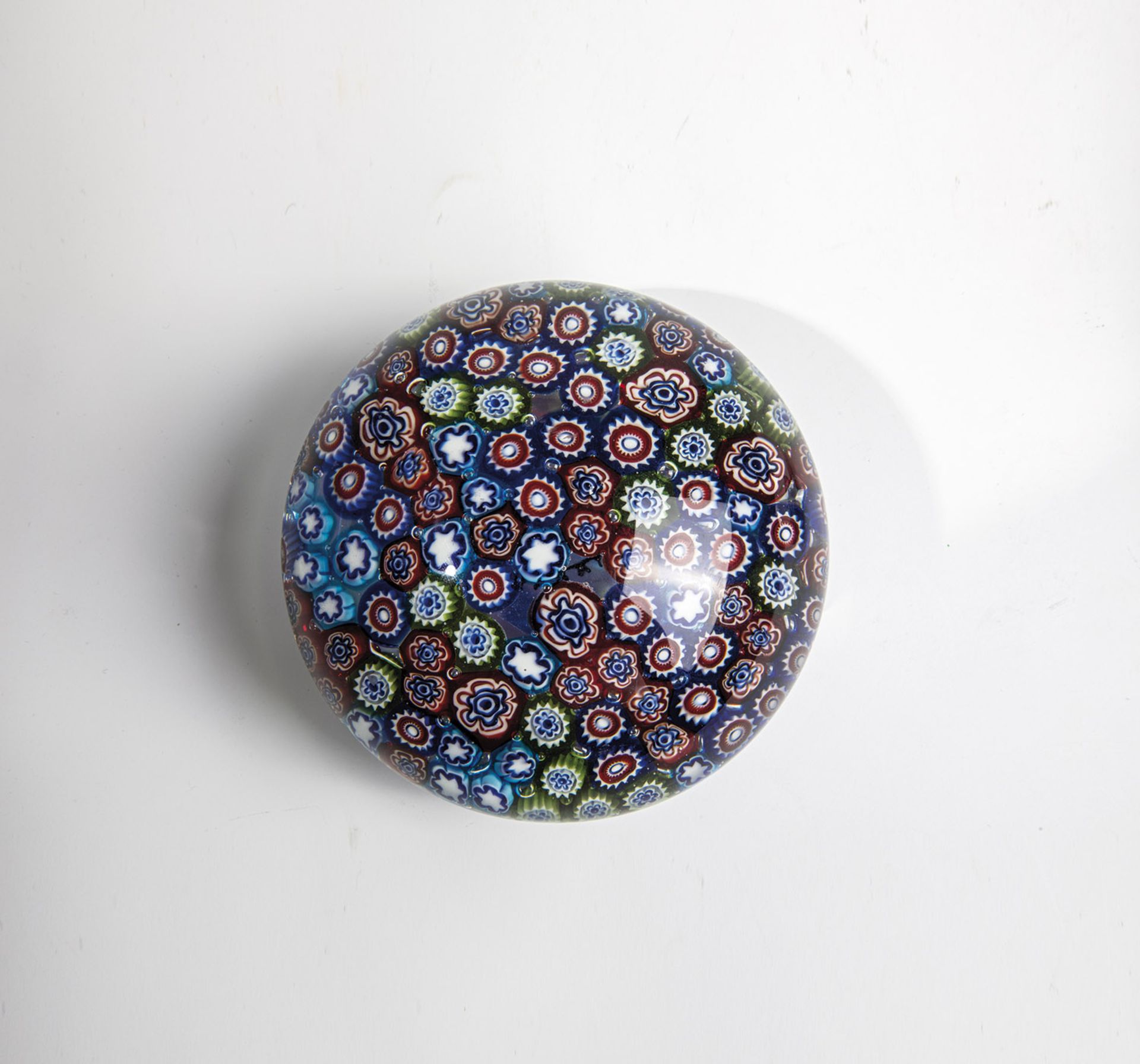 Large paperweight Murano, 20th century Millefioricanes laid on colorless upholstery. 13x8cm.
