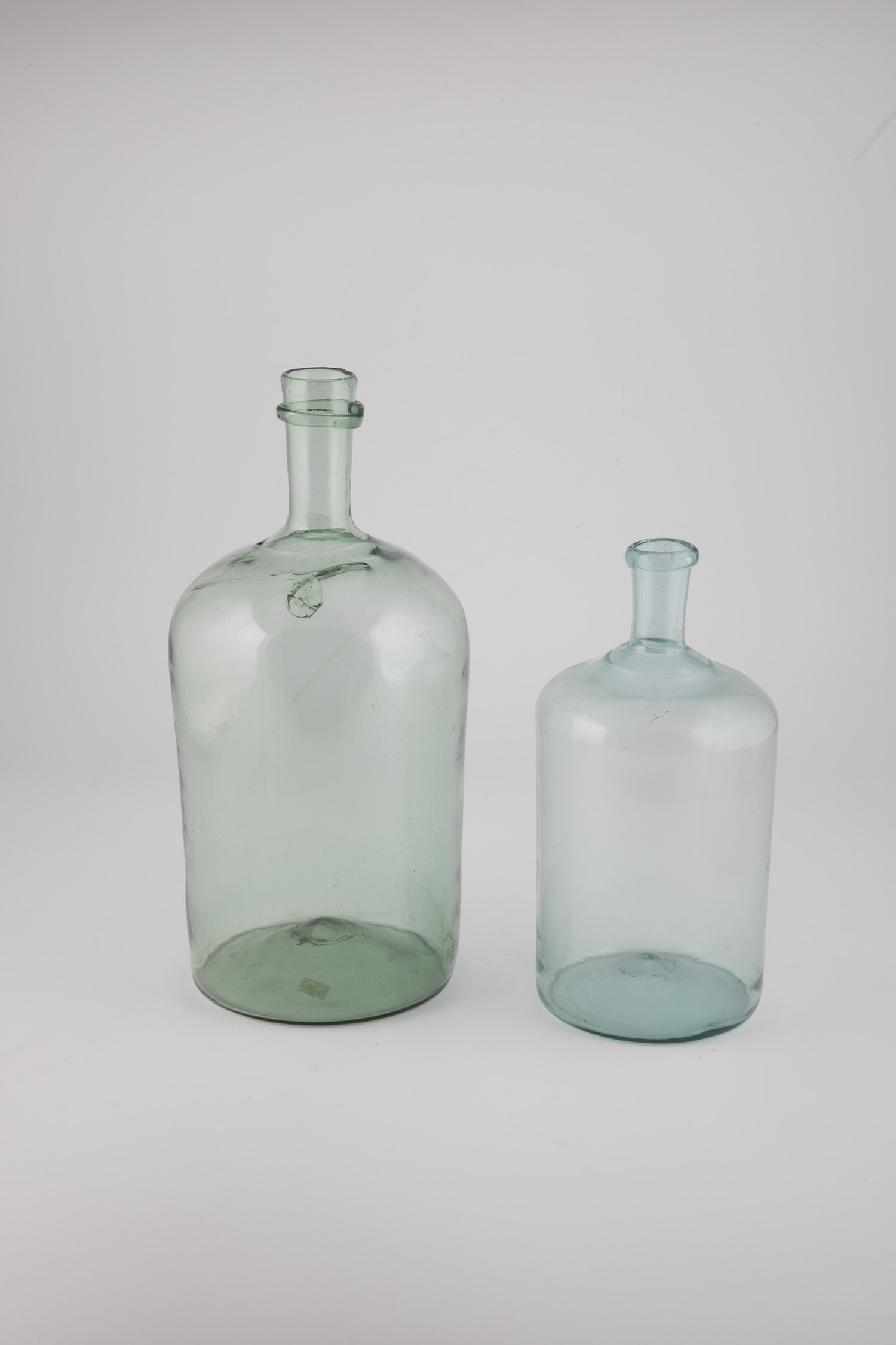 Two storage bottles of Austria, 19th century Light green glass with a raised bottom and tear-off. On