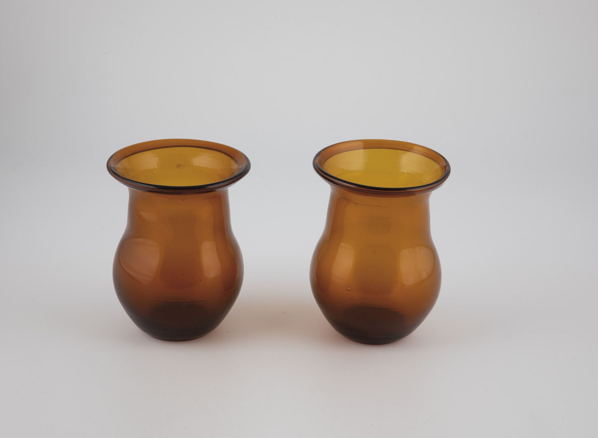 Two storage jars, 19th/20th century, brown glass. H. 14.5 cm