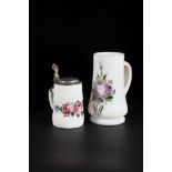 Two jugs of Black Forest, 19th century frosted glass with stylized peonies in polychrome enamel