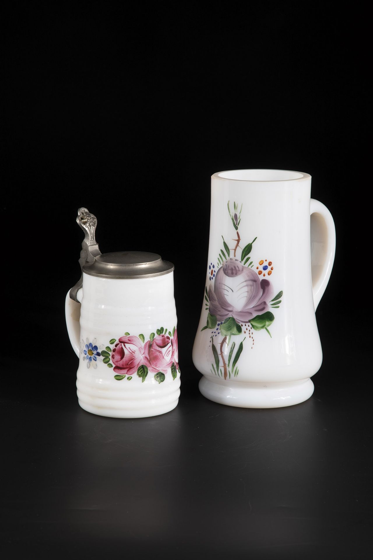 Two jugs of Black Forest, 19th century frosted glass with stylized peonies in polychrome enamel