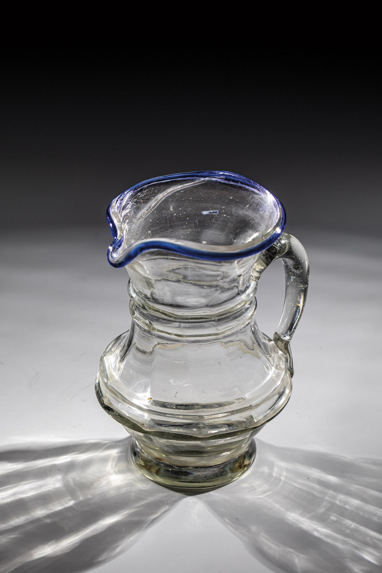 Jug with blue rim Freck/Porumbac, E. 18th / A. 19th century Grey-tinted glass with tear-off.