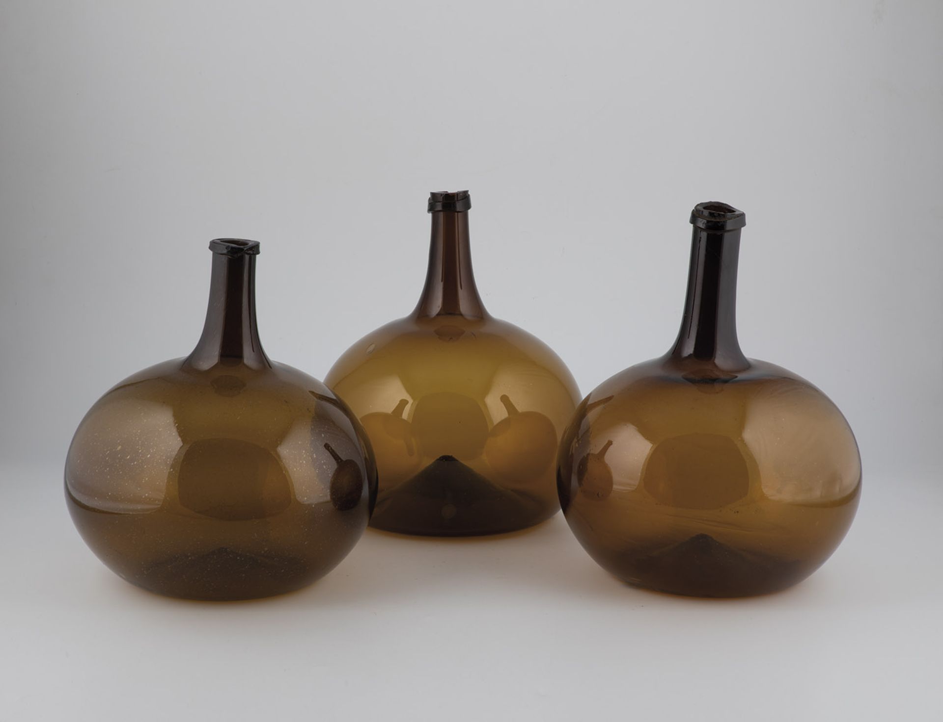 Three large spherical bottles from Alsace, 19th century Brown, partly bubbled glass. Slightly