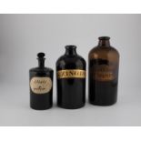 Three large pharmacy bottles England, 19th century Dark or reddish-brown glass with tear-off. One