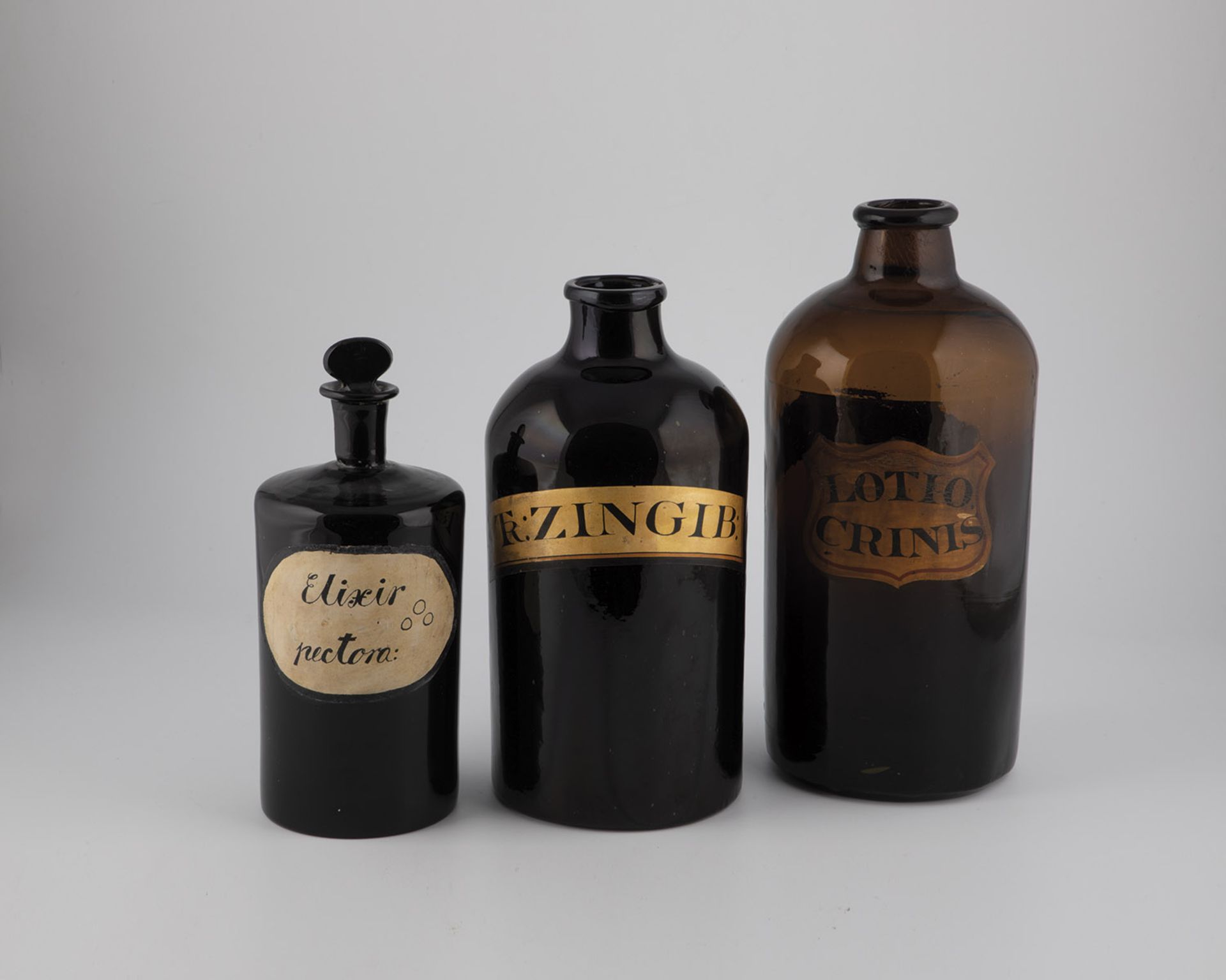 Three large pharmacy bottles England, 19th century Dark or reddish-brown glass with tear-off. One