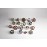 Eighteen paperweights 20th century Mixed lot of eighteen paperweights with trumpet flowers and other