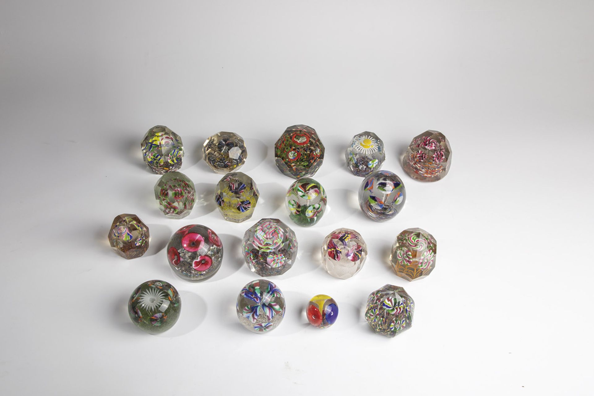 Eighteen paperweights 20th century Mixed lot of eighteen paperweights with trumpet flowers and other