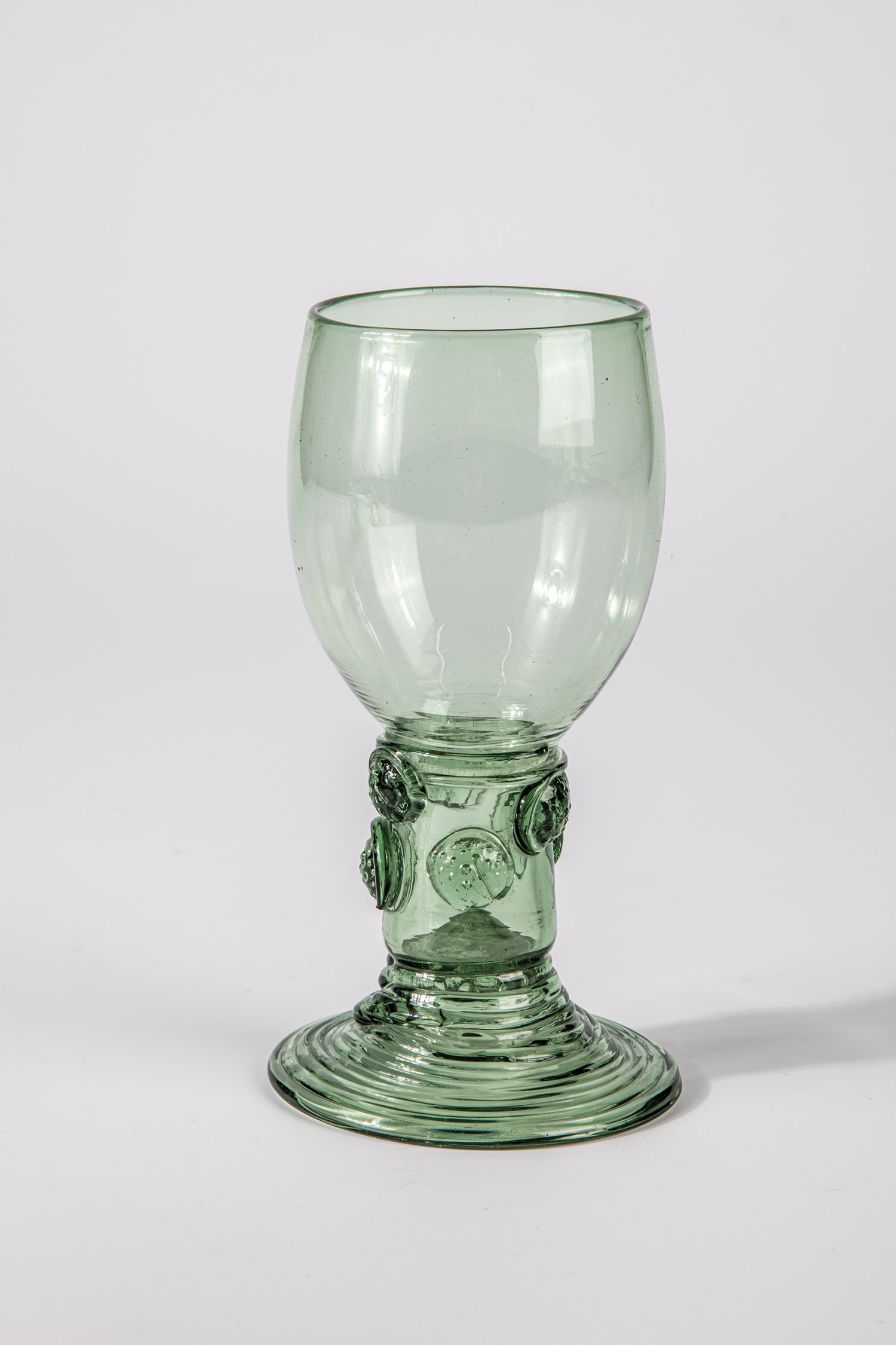 Roemer German, E. 18th century Green glass with flat, spun base, hollow shaft open to the top with