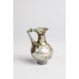 Small jug Eastern Mediterranean, 3rd-4th century AD. Light green glass. Appliqued base ring and