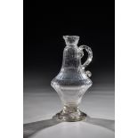 Small oil jug 18th century, colourless glass. Disc base with tear. Longitudinally optically blown