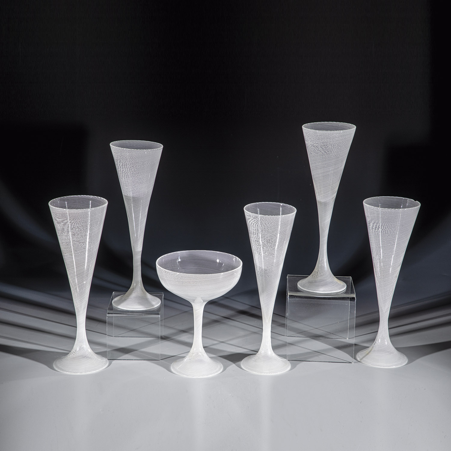 5 flutes and 1 champagne bowl from the series ''filigrana lattimo'' Tapio Wirkkala (design), Venini,