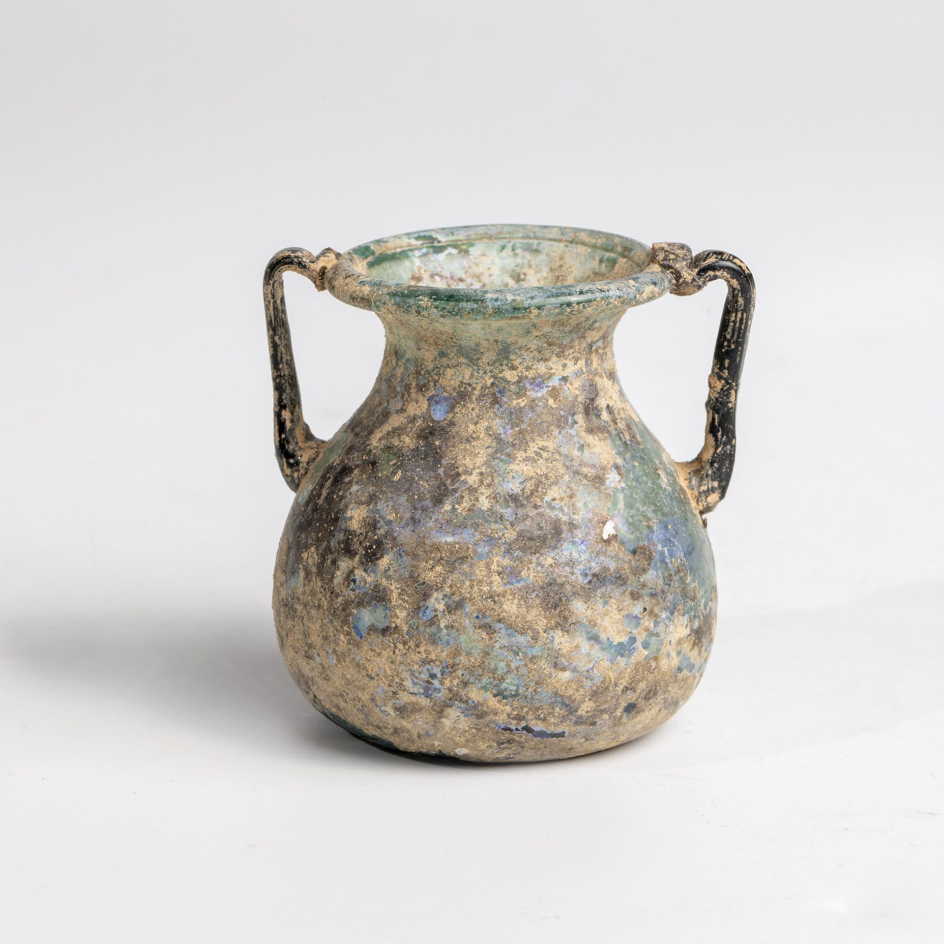 Small double-handled vase Eastern Mediterranean, 1st-3rd century AD. Light green glass with a