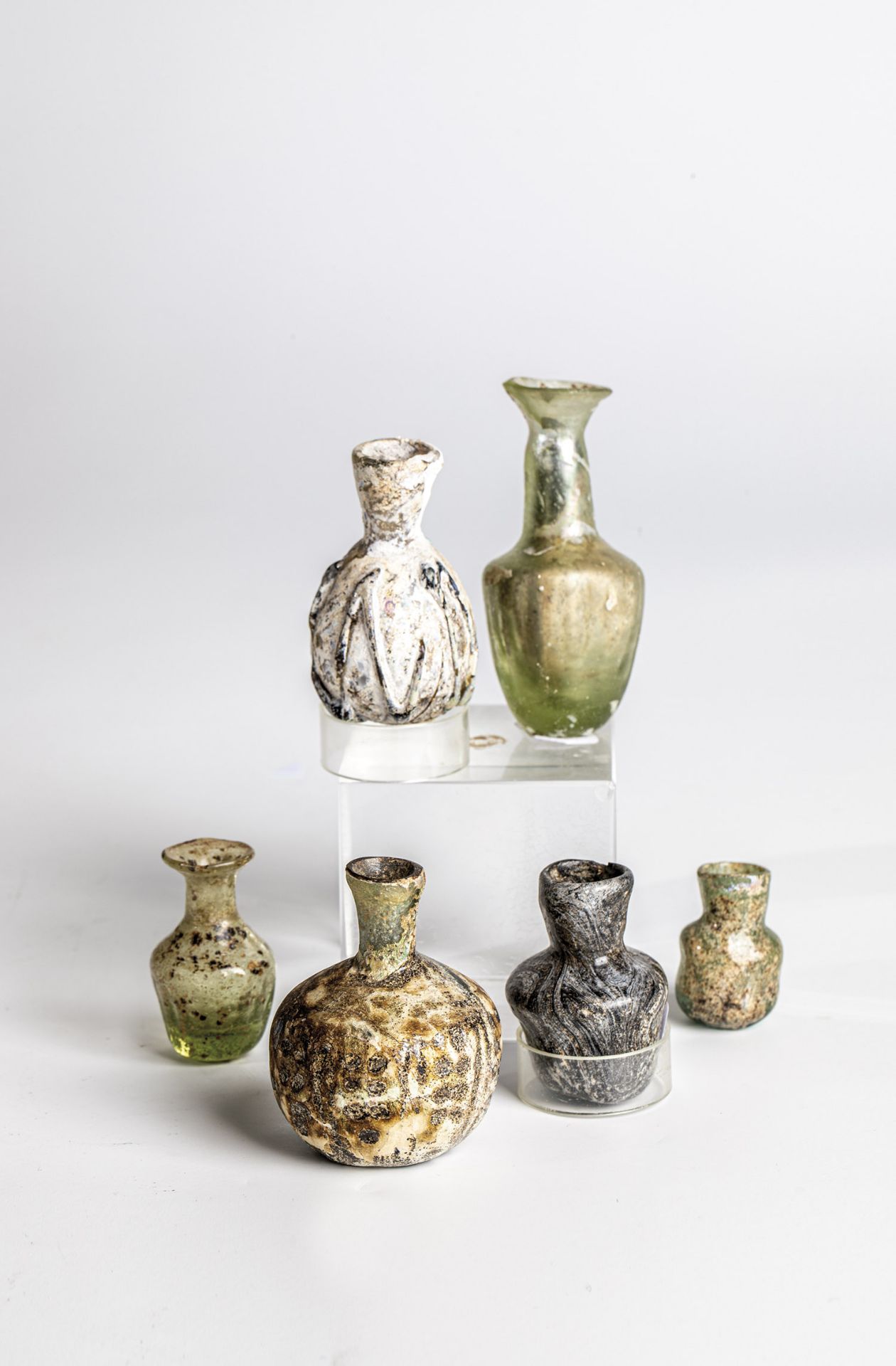 Mixed lot: six excavations in the Middle East, 1st/3rd century Green-tinted or grey-brown marbled