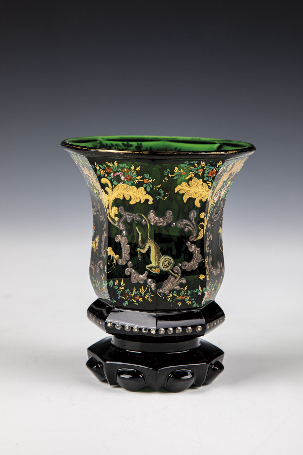 Mug with animals North Bohemia, ca. 1845 Dark green glass, faceted wall that widens eight times