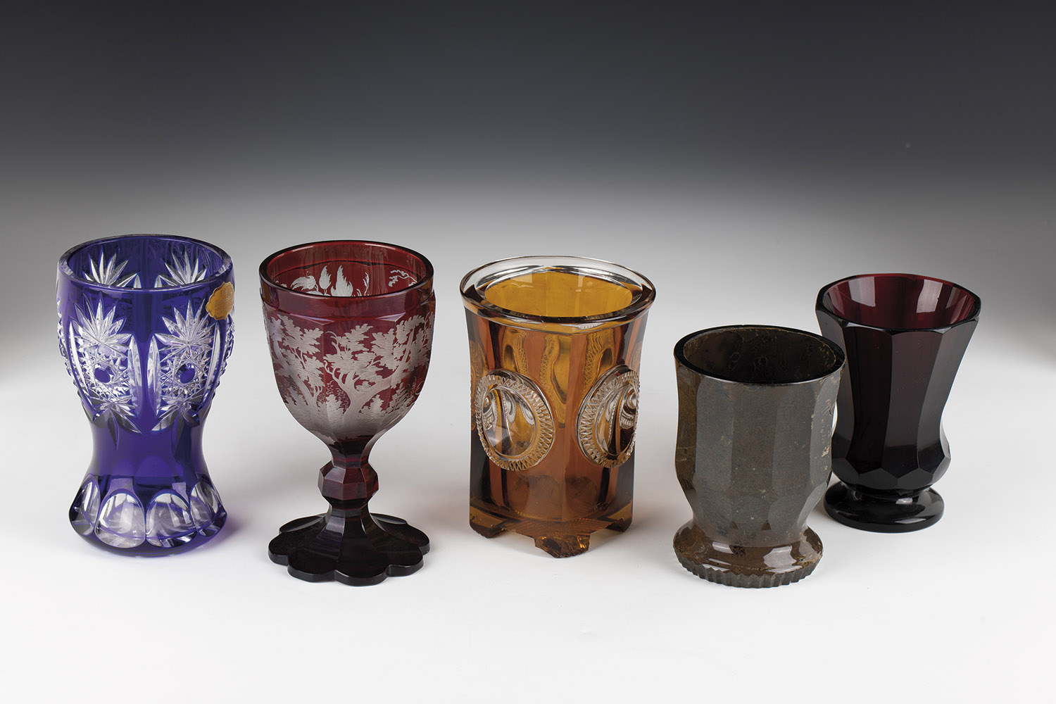 Mixed lot of five cups Bohemia 19th/20th century stone glass or colourless glass with glazes in red,