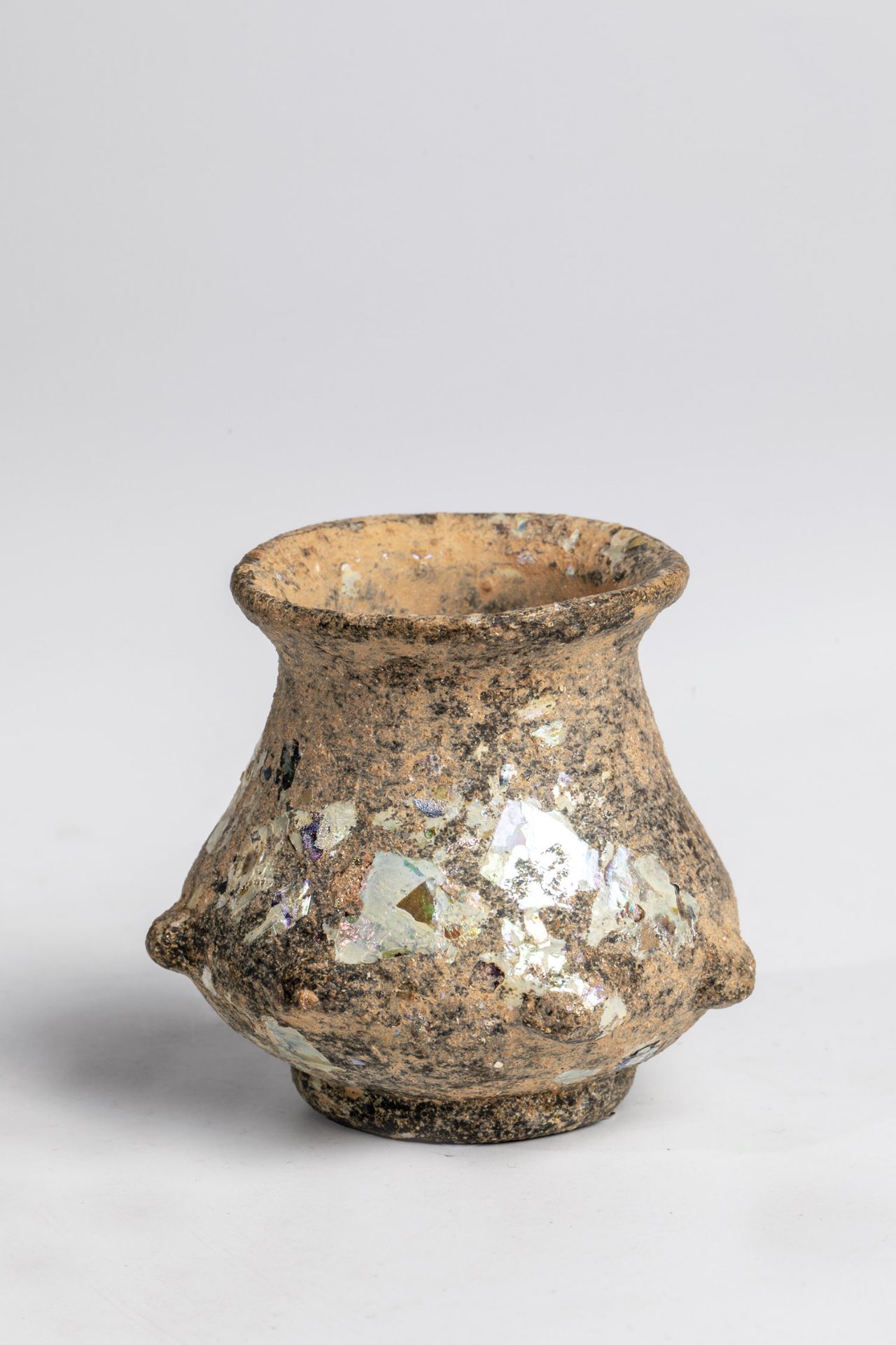 Small dimpled vessel Eastern Mediterranean, 3rd-4th century. Probably colorless glass. Teardrop-