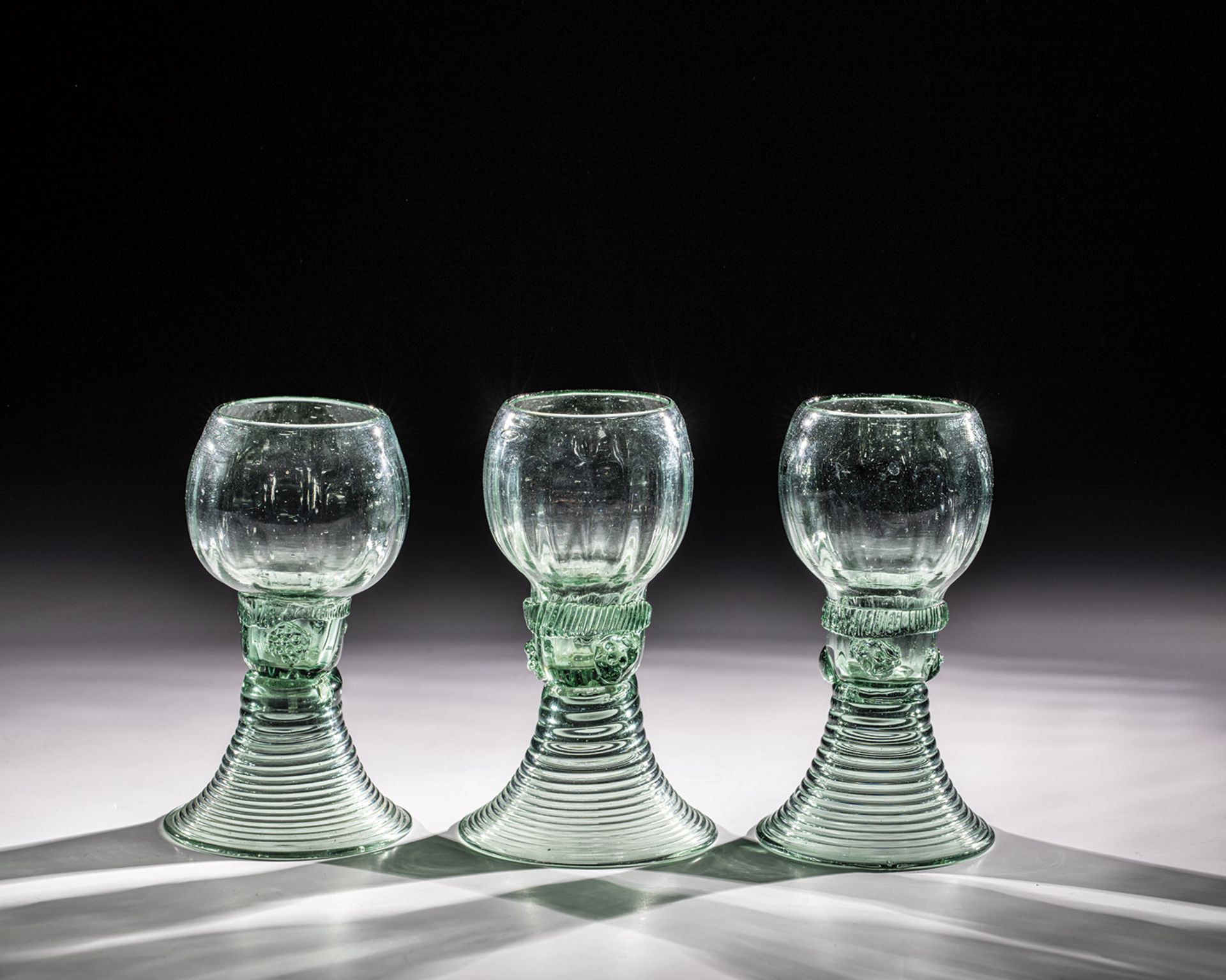 Set of three Romans Germany, 18th century Light green glass with demolition. Flared, spun foot. On