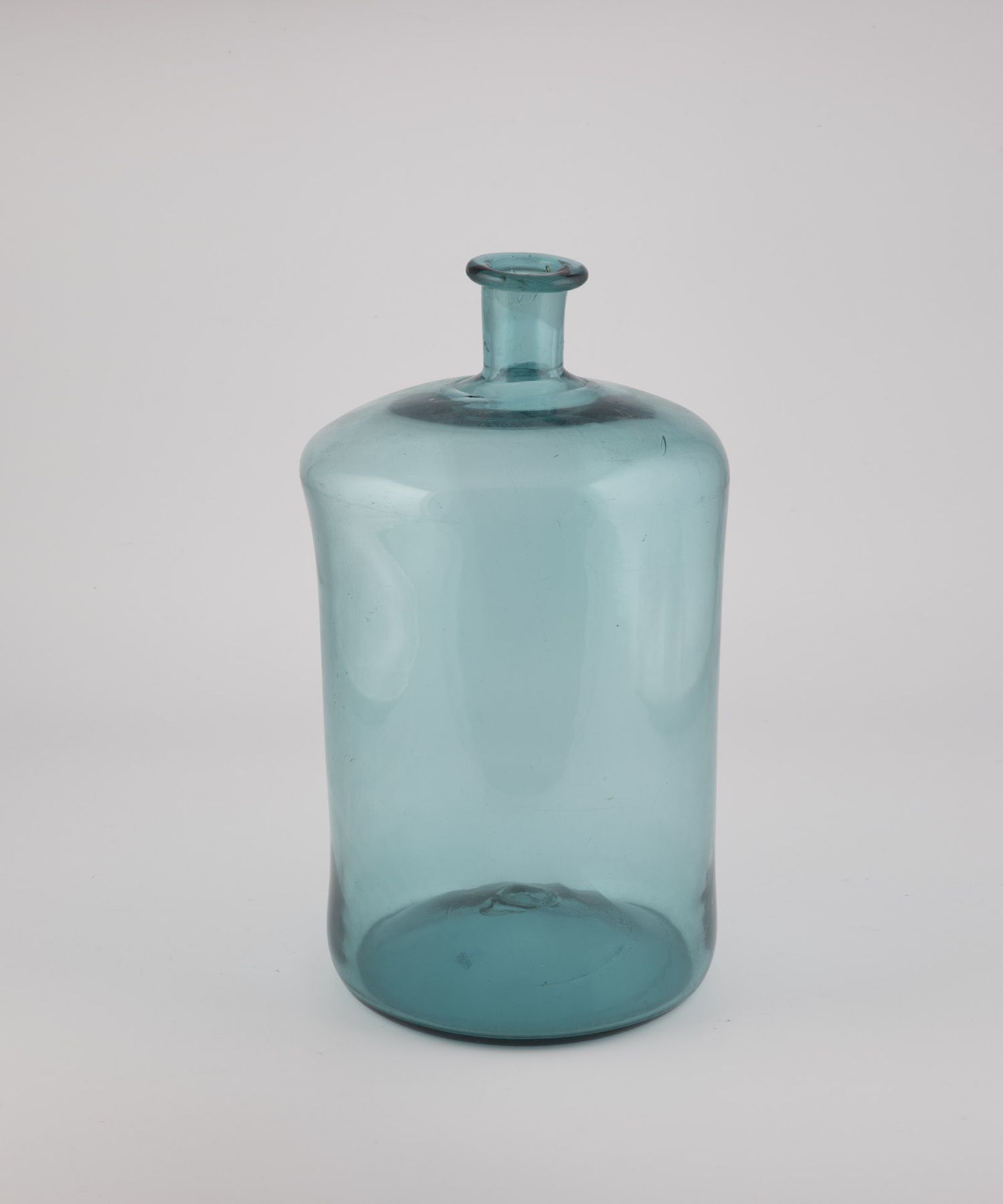 Large storage bottle Austria, 19th century Blue-green glass with raised bottom and tear-off. Tubular