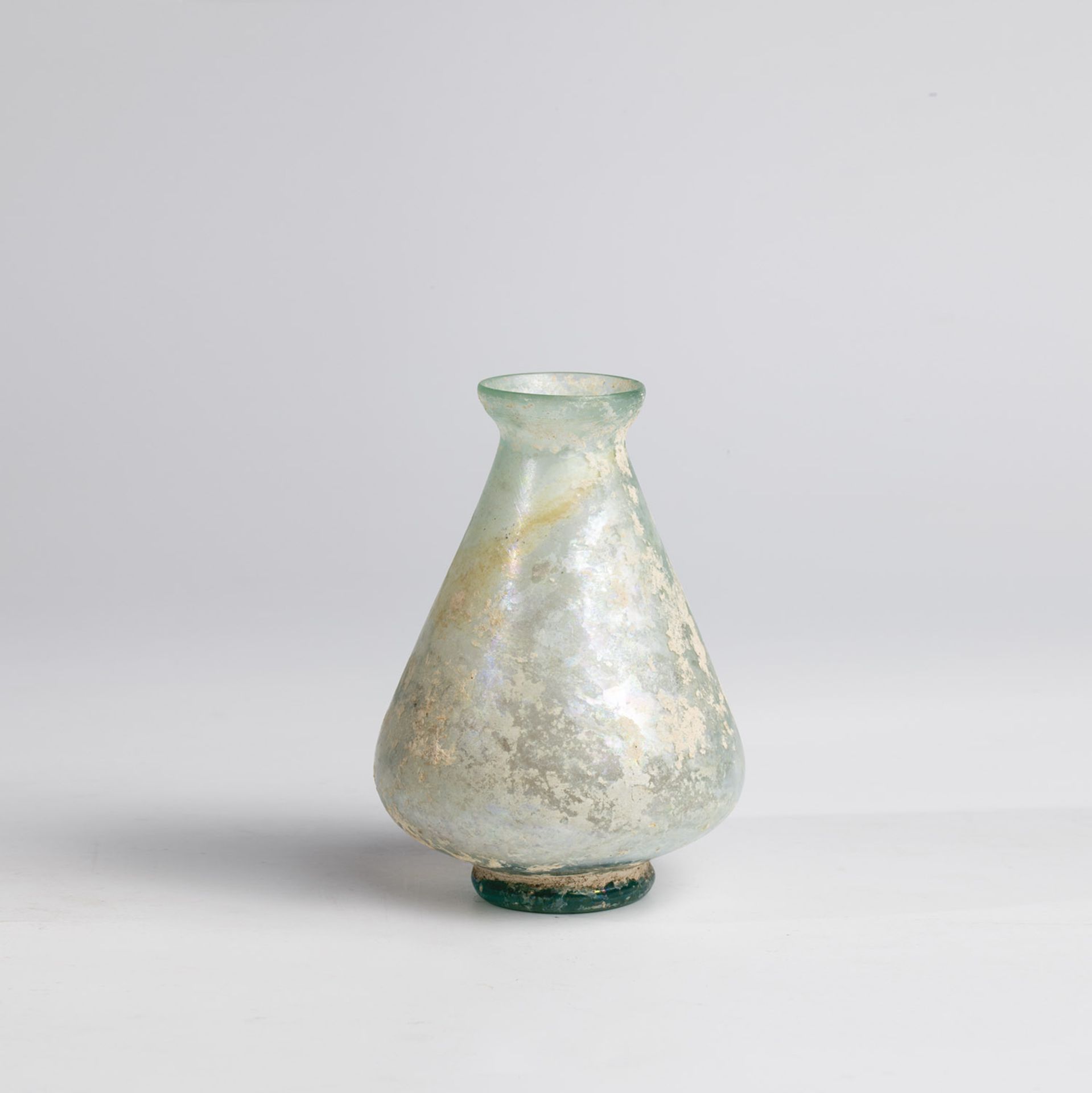 Bottle Middle East, 2nd-4th century AD Bottom find. Light green glass. Pear-shaped wall on applied