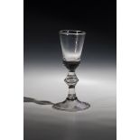 Shot glass, 18th century, disc base with downward turned-edge. Baluster shaft with punctured air