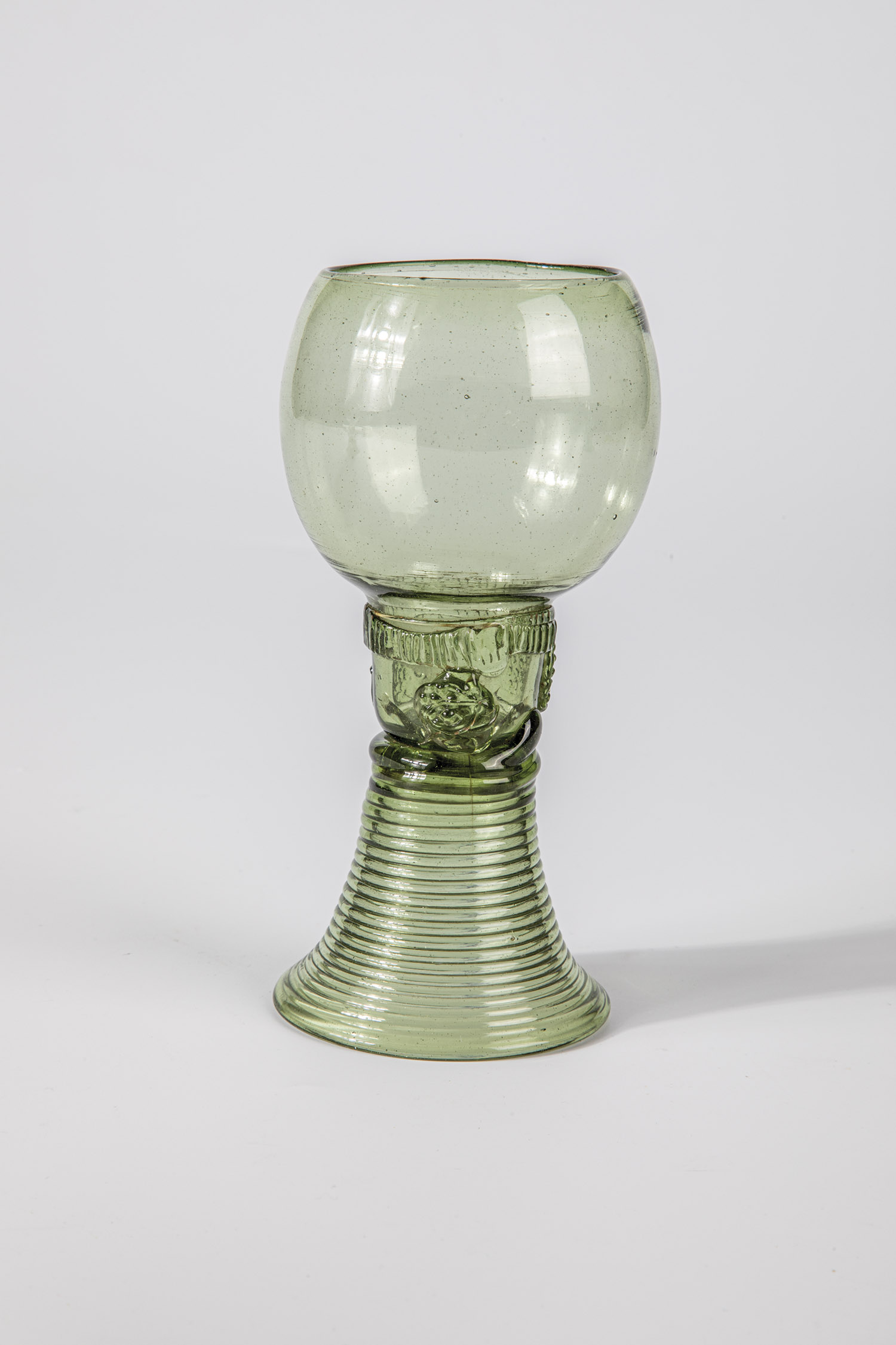 Roman German, A. 18th century Light green glass with tear-off. Spun foot, shaft open at the top with