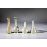 Four long-necked bottles Eastern Mediterranean, 1st-4th century AD. Greenish glass. One vial