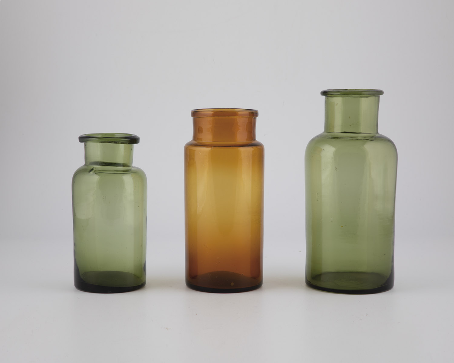 Three storage vessels, including northern Germany, 19th century, green and brown glass.