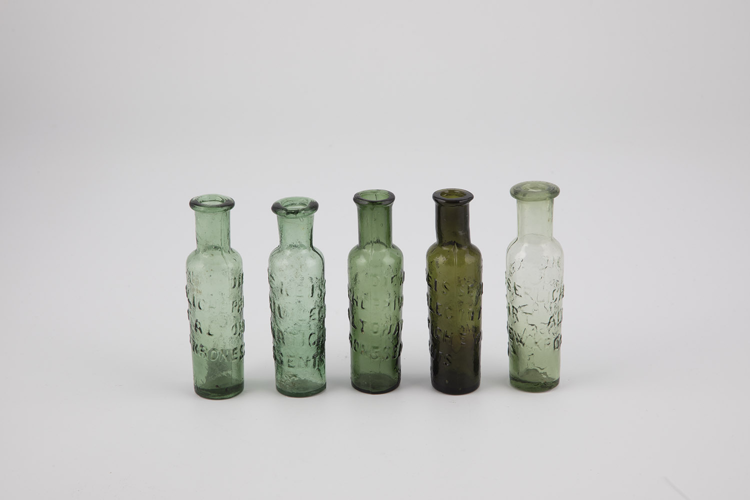 Five glass vials for Altona miracle cure Germany, 19th century Green or olive-coloured glass.