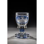 Colourless, partly blue glazed glass. Six-pass foot. Underside with engraved floral decoration.