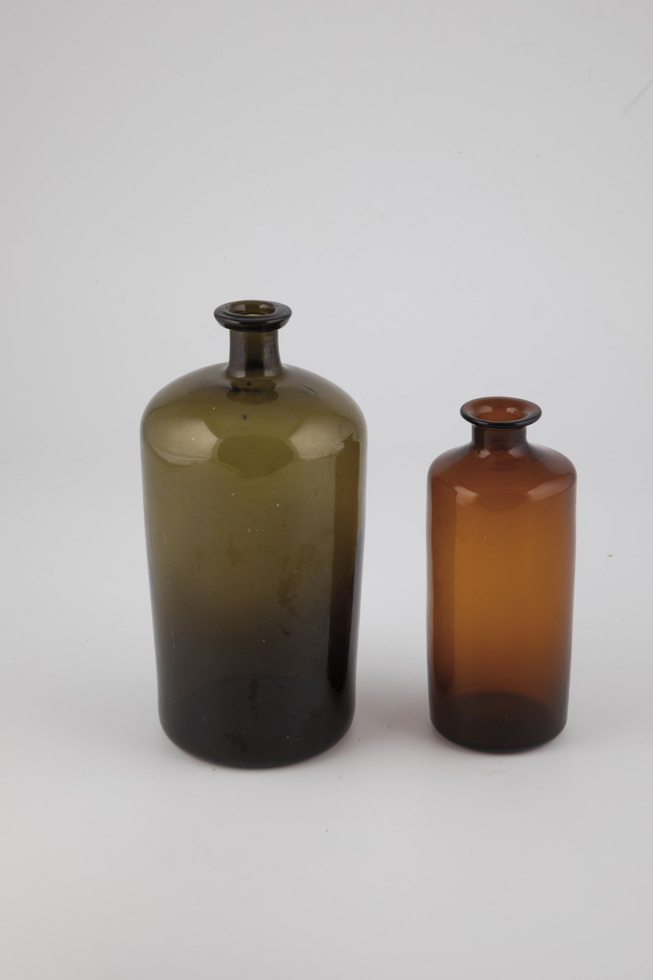 Two bottles of Germany, 19th century Olive and brown glass, one with a slightly raised bottom and