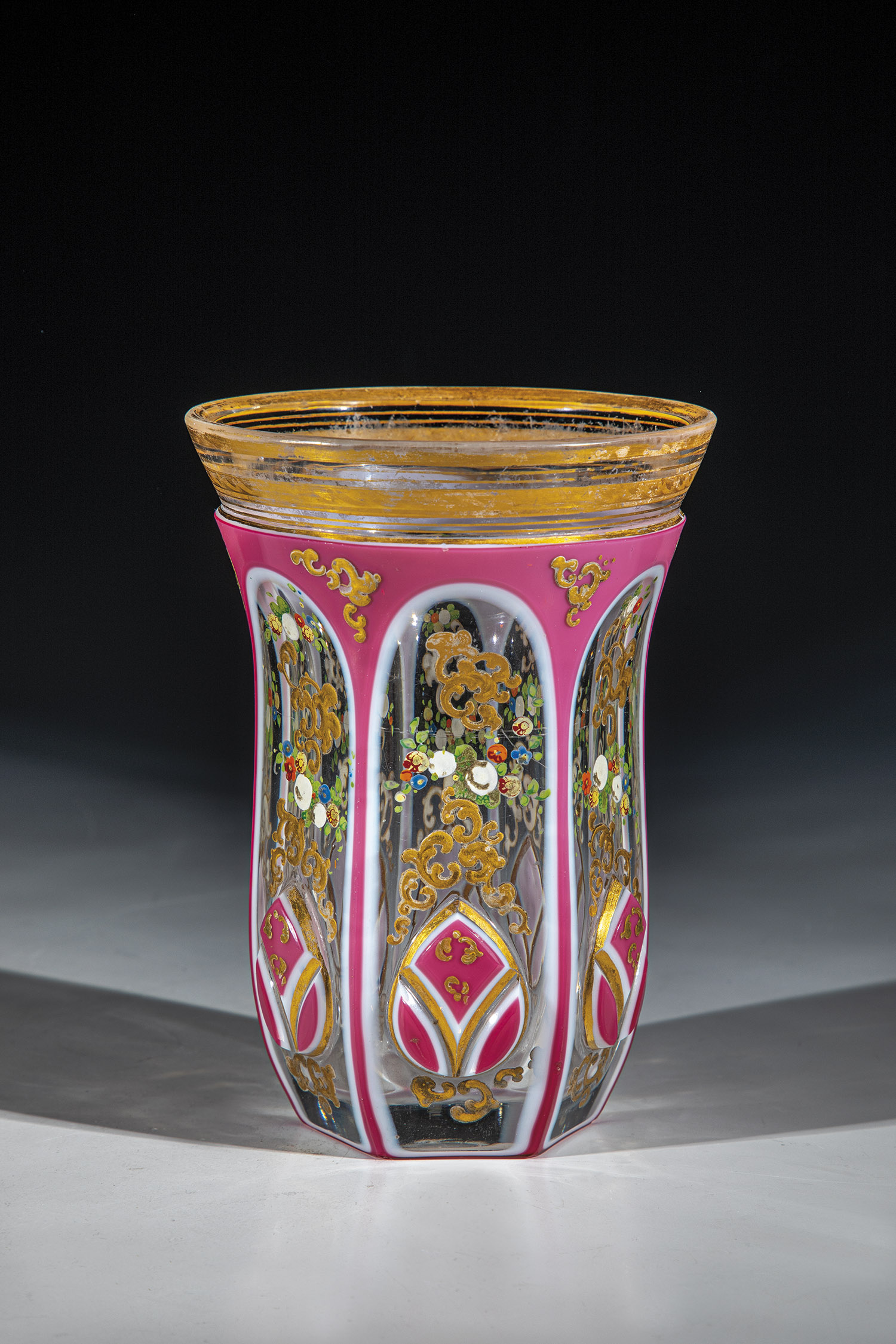 Tumbler with double overlay Bohemia, ca. 1850 Colourless glass with pewter enamel and pink