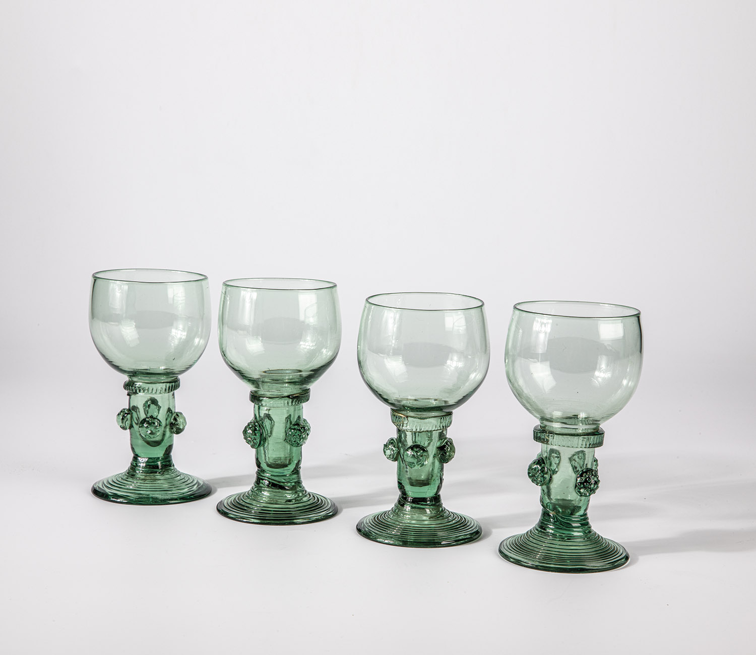 Four Romans German, 18th century Green glass with demolition. Slightly rising, spun foot. Hollow