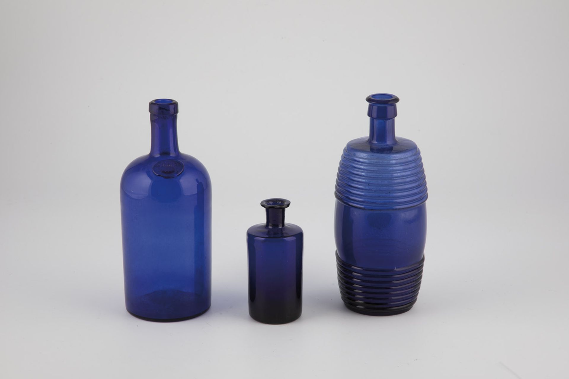 Three cobalt blue glass bottles Austria, Bad Gleichenberg, 19th century Two parts with demolition. A