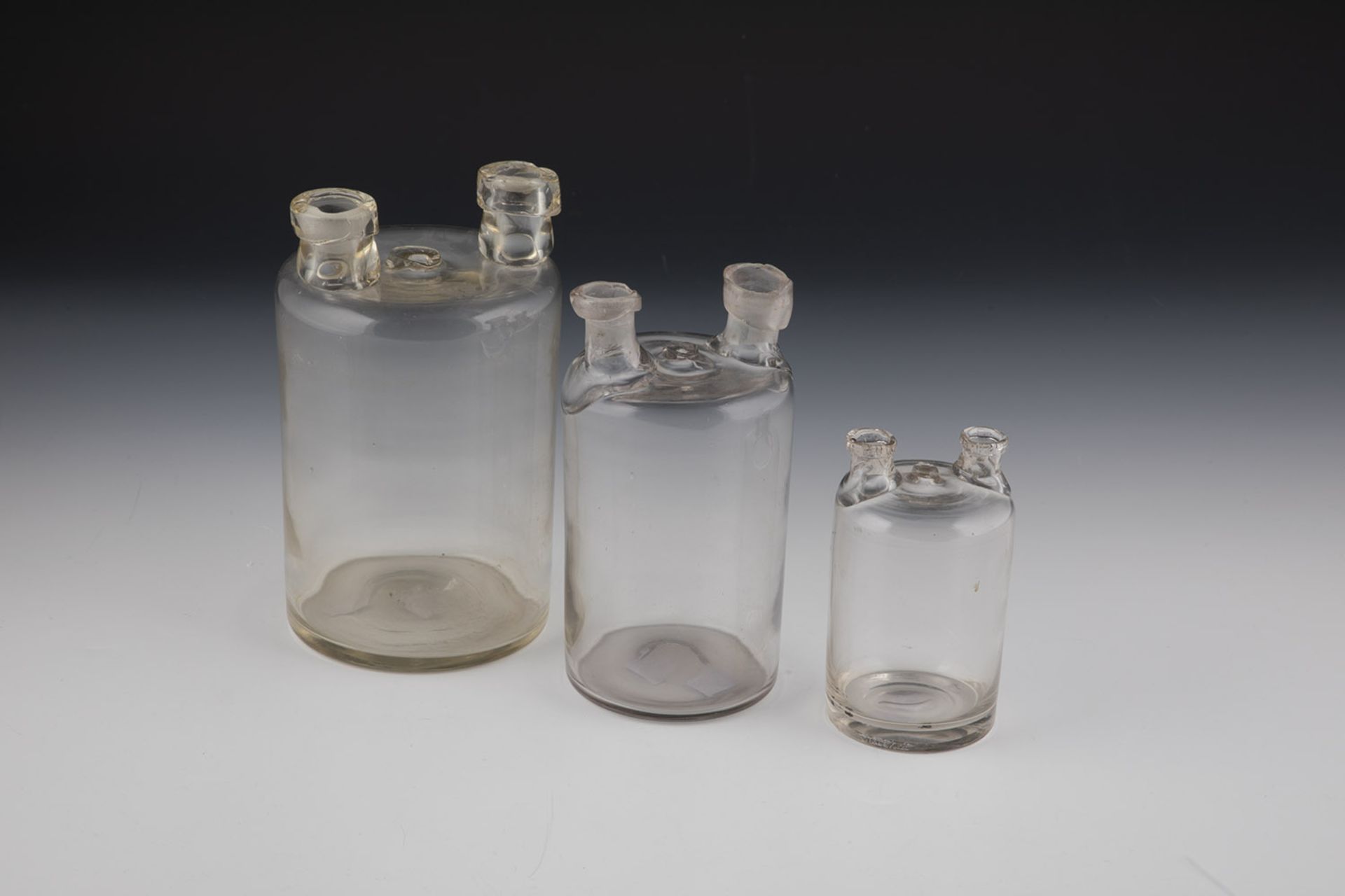 Three pharmacy bottles (so-called Woulfesche bottles) Germany, 19th century Colourless glass.