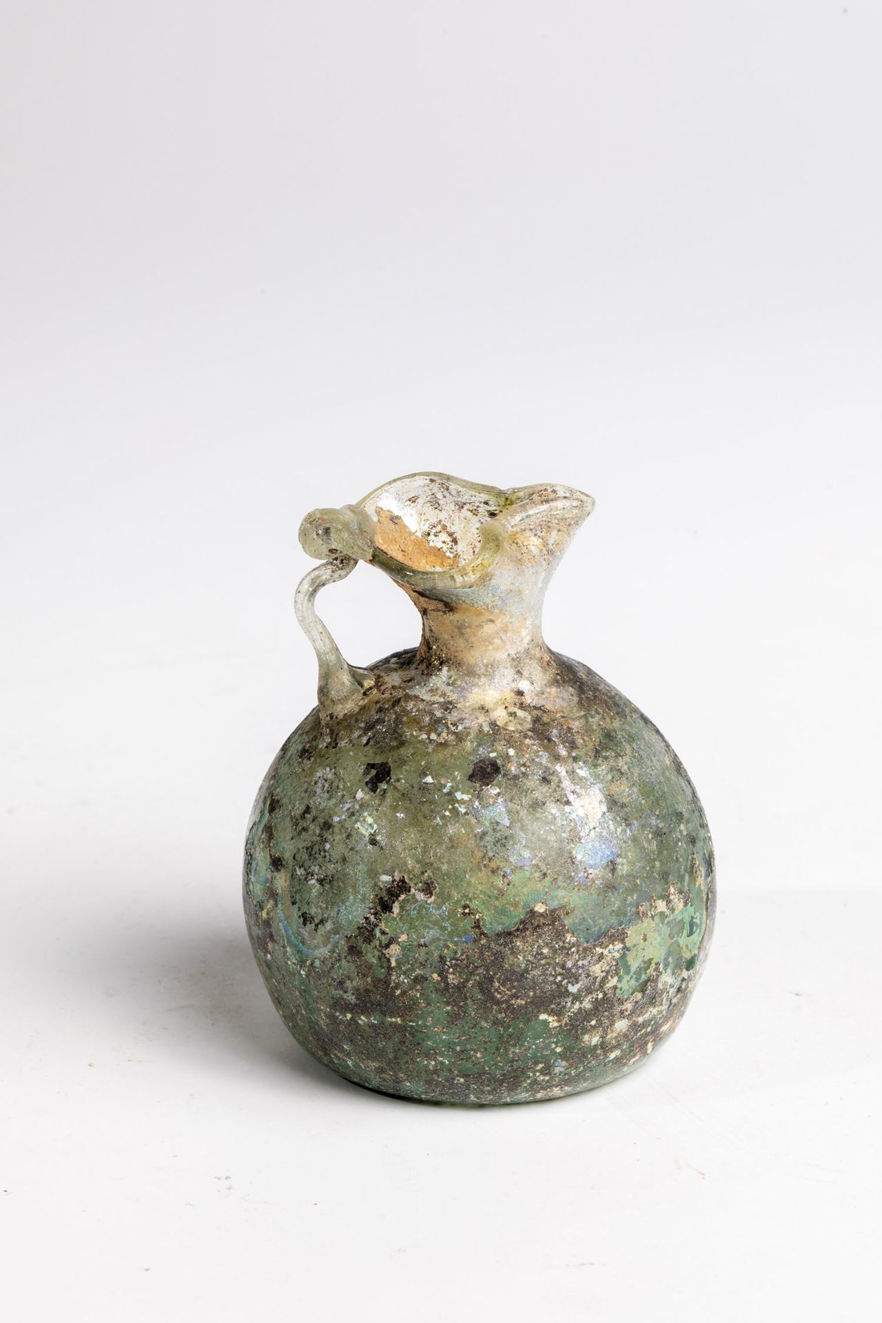 Small jug Eastern Mediterranean, 3rd-4th century AD. Light green, longitudinal optical glass with