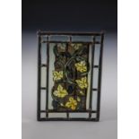 Leaded glazing with vine tendrils German, 19th century Colourless glass, painted in silver yellow,