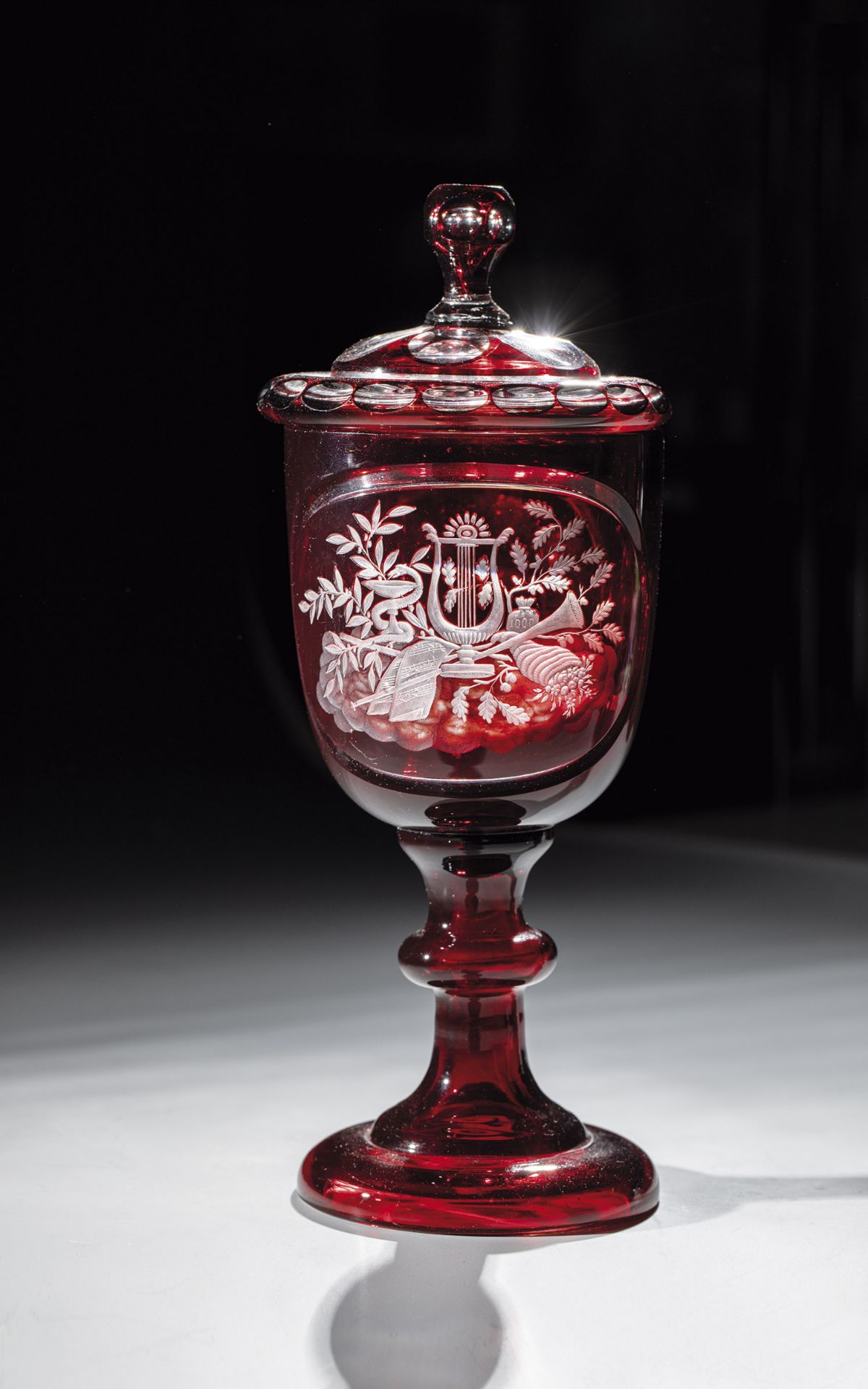 Lidded goblet Bohemia, mid-19th century Colourless glass with ruby red overlay. Allegories cut