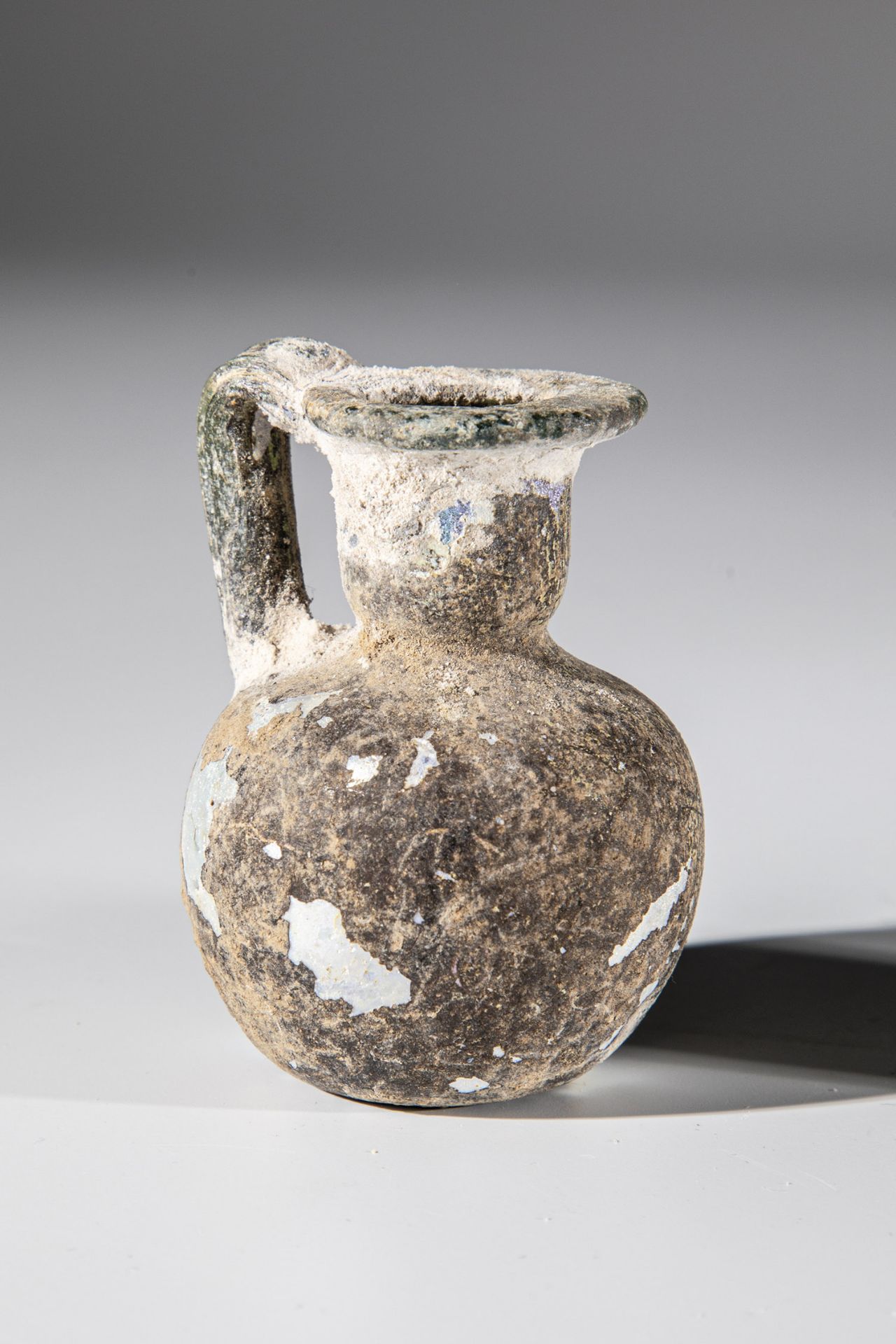 Small jug Eastern Mediterranean, 2nd-4th century A.D. Greenish glass. Ball belly, neck