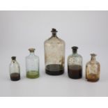 Five medicine vials with contents probably Austria Colourless and greenish glass, partly corked.